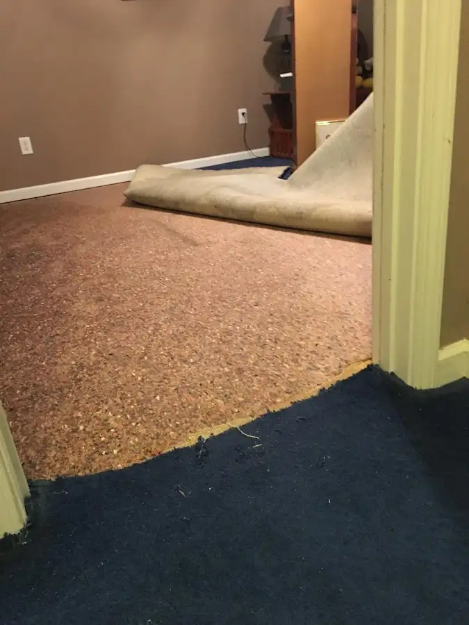 Carpet pad removal revealing water damage during Drying & Dehumidification in Creston